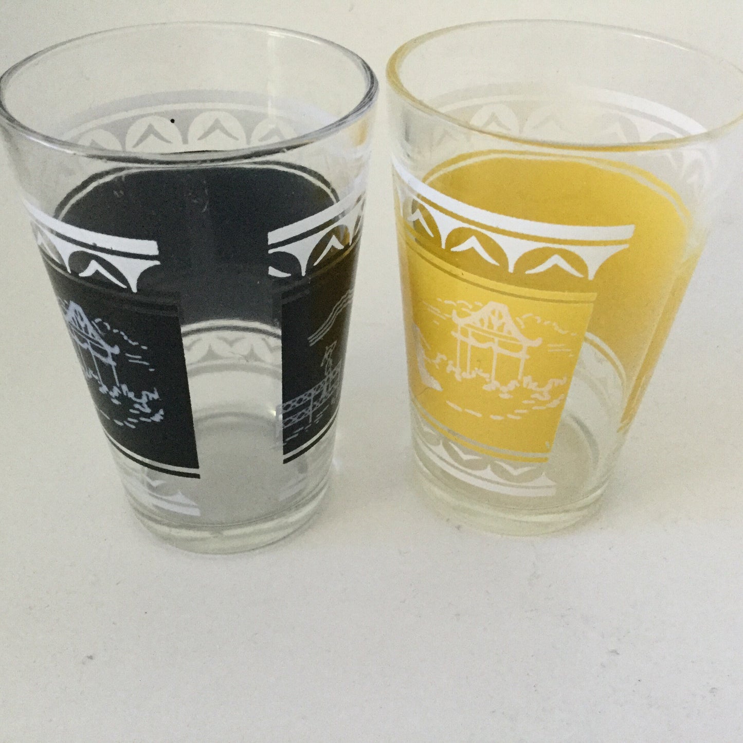 Two drinking glasses with Chinese pagoda and garden scene - small decorative glasses, mid century