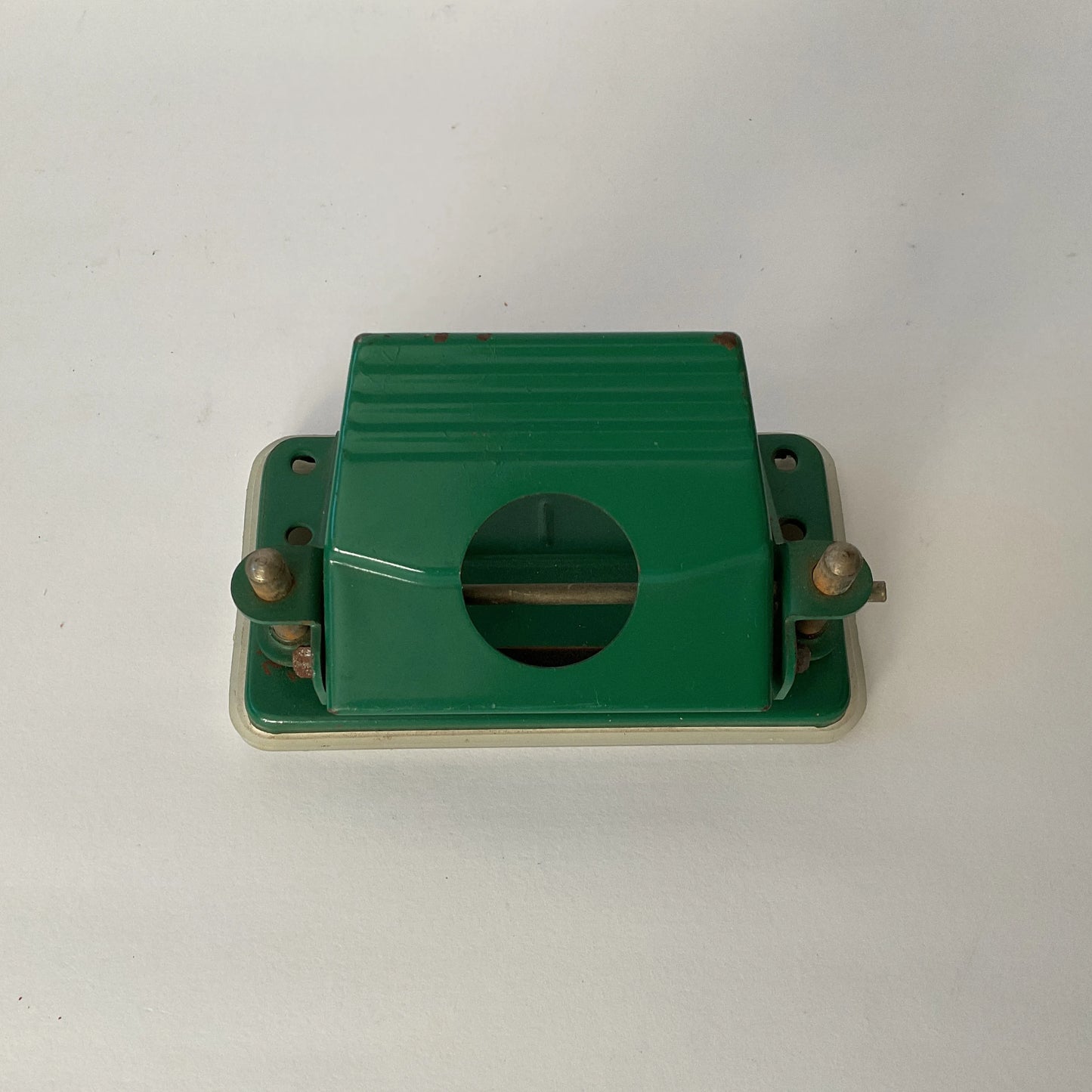 Vintage small green metal hole punch, classic office desk accessory, some rust on edges